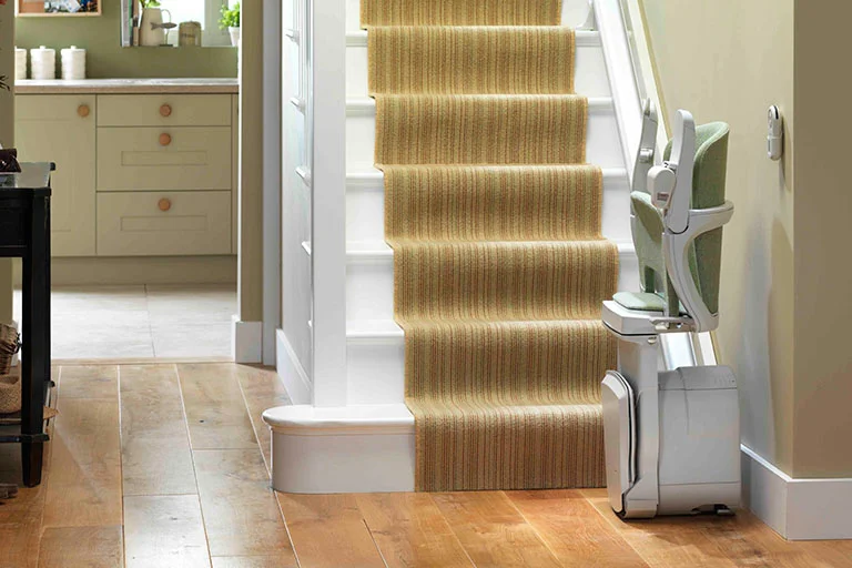 troubleshooting stairlift batteries A gentleman sitting on a Stannah stairlift