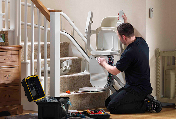 Engineer A Stannah engineer is inspecting a stair lift