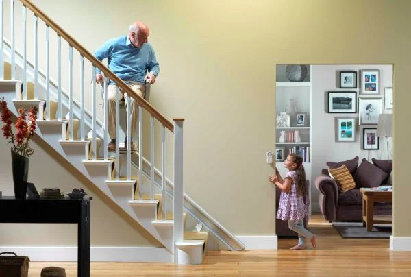 Stannah stairlift home page split test Man on stairlift going up the stairs