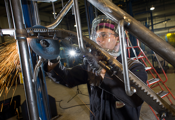 Stuart Peckham welder working with grinder on metal rube