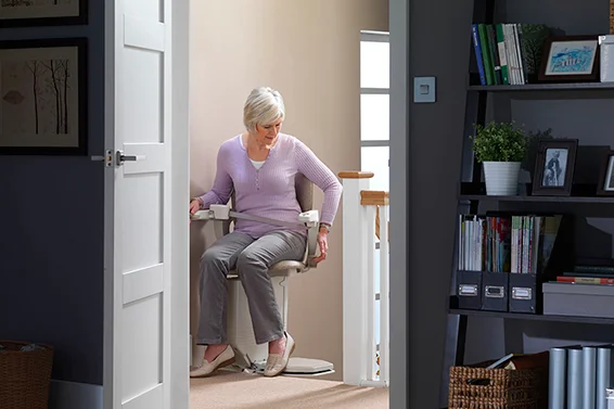 en woman stairlift A stannah engineer assisting a customer and her daughter