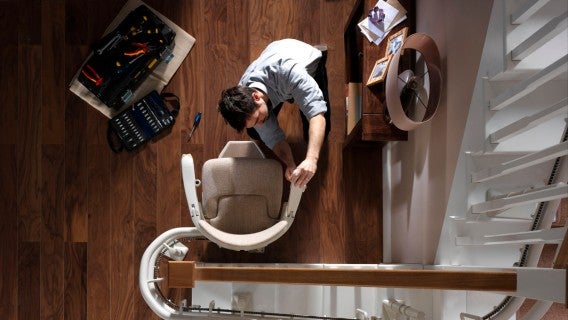 contact serv Stannah engineer repairing a stairlift